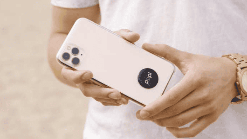 Image of a person carrying a phone with a popl flat on the back.